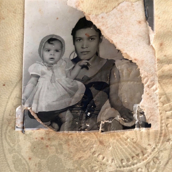 Mary sitting on Rosario's lap superimposed on Rosario's passport.